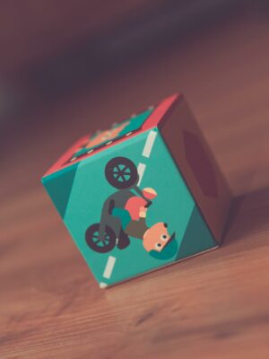 A close-up of a colorful toy cube on wooden floor, emphasizing play and childhood.