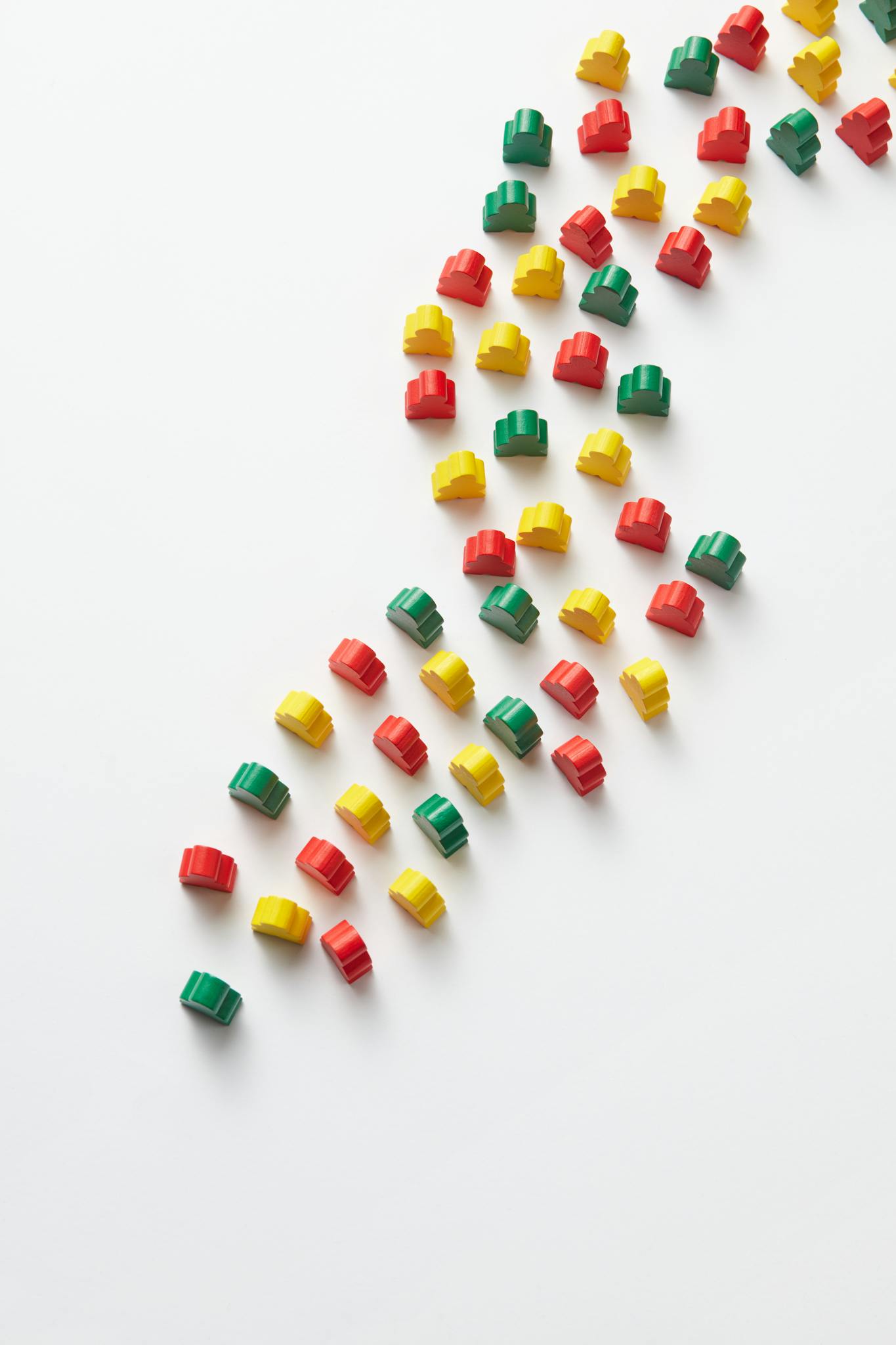 Vibrant red, yellow, and green toy blocks arranged on a white background for creative design.